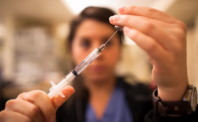 Nurse prepares syringe syringe