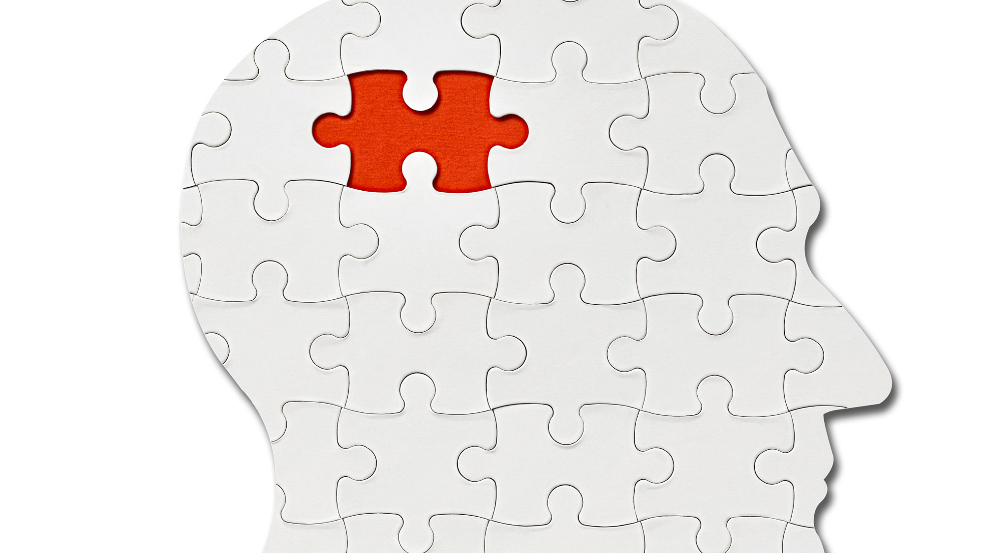 head made out of puzzles pieces with final one about to be added