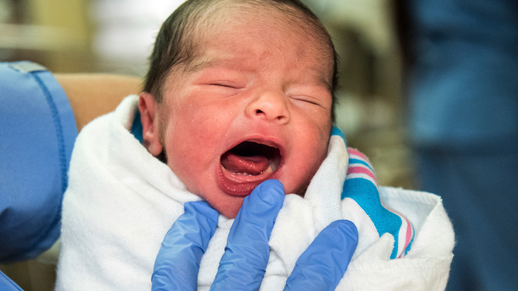 Swaddled newborn with a healthy cry