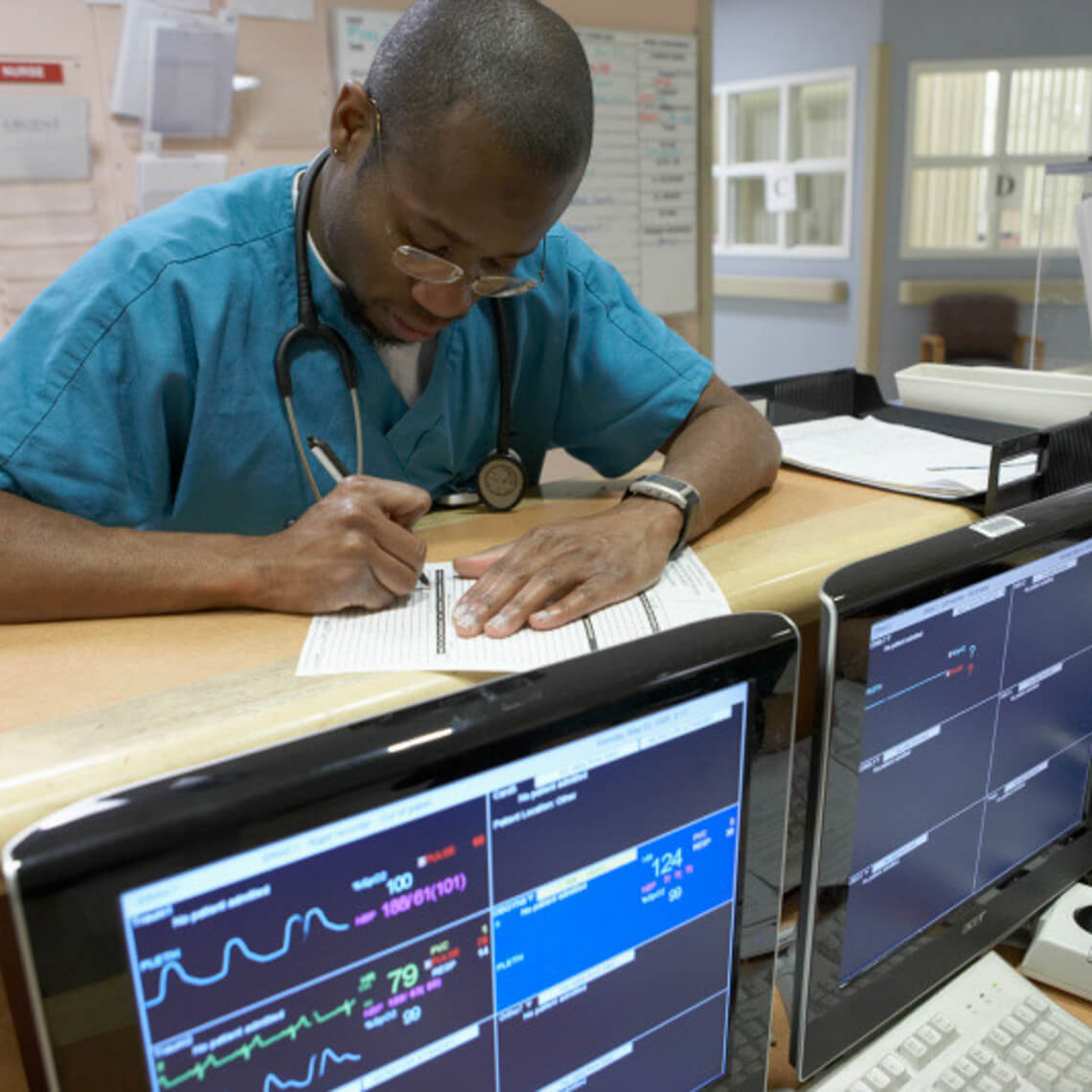 clincal clerk entering chart information at desk