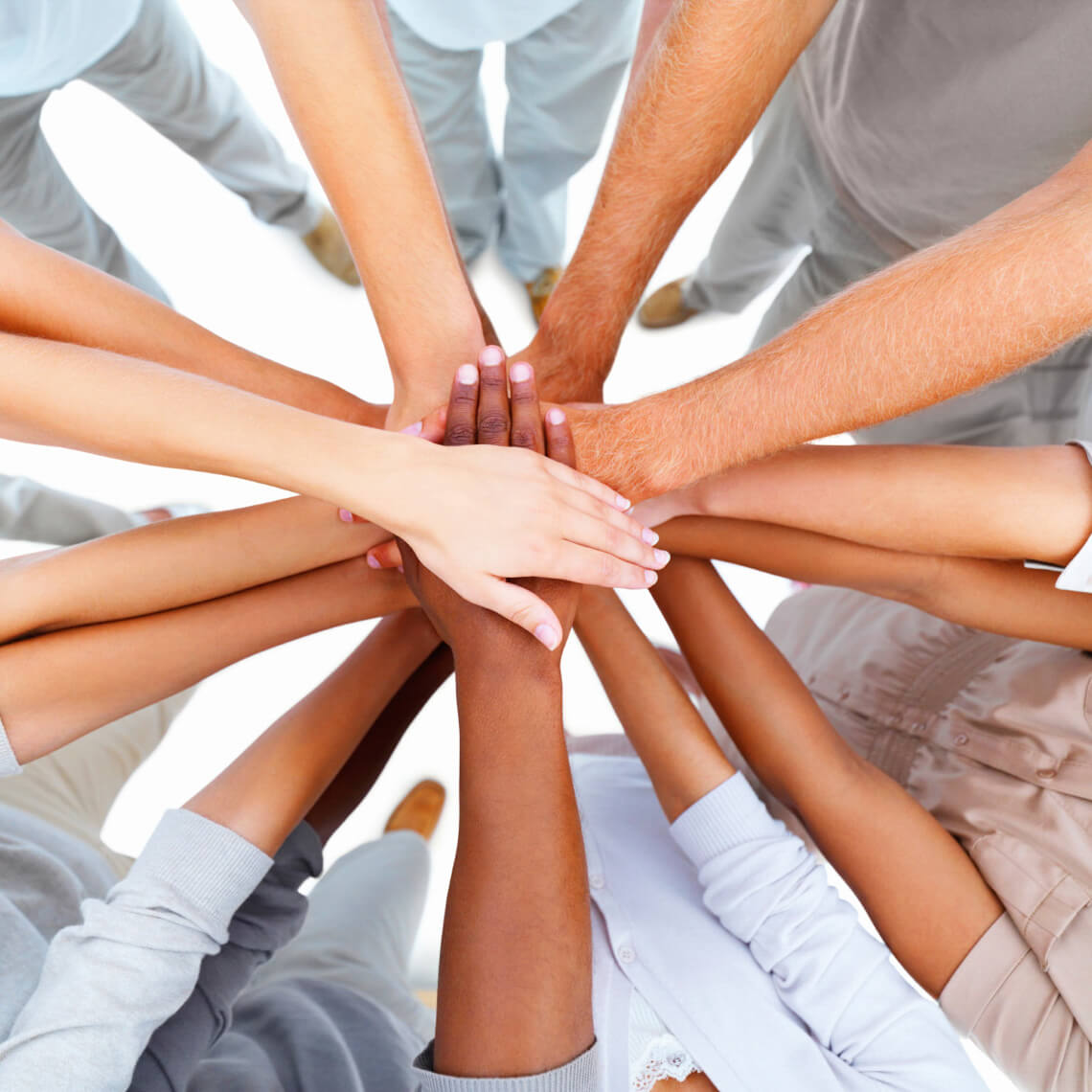 teamwork shown by many hands in a huddle