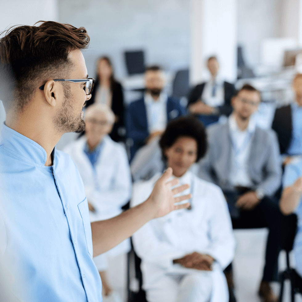 clinicians in a class setting smiling