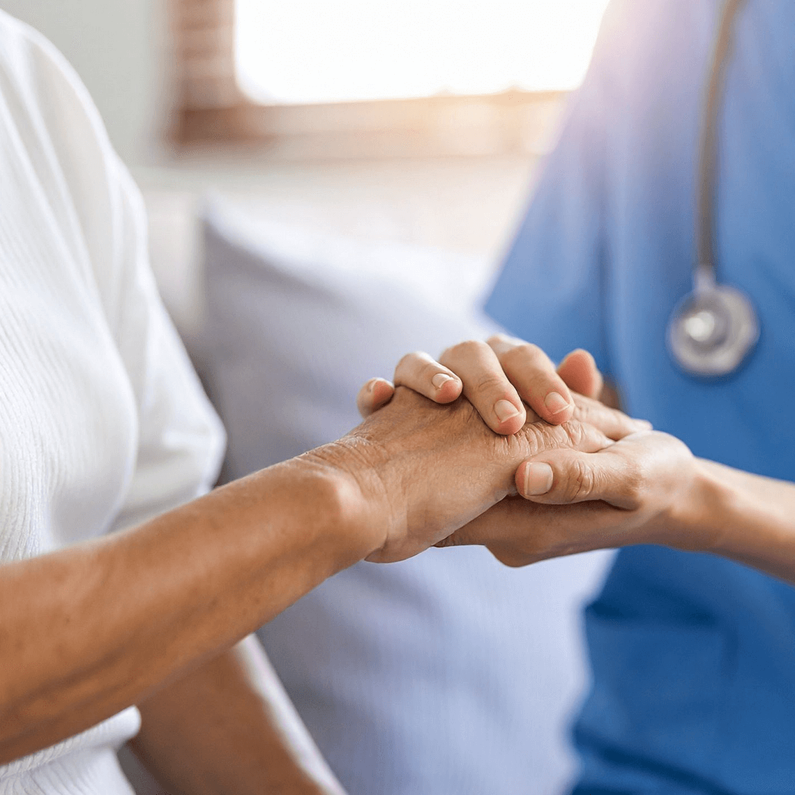 Clinician holds hand of patient