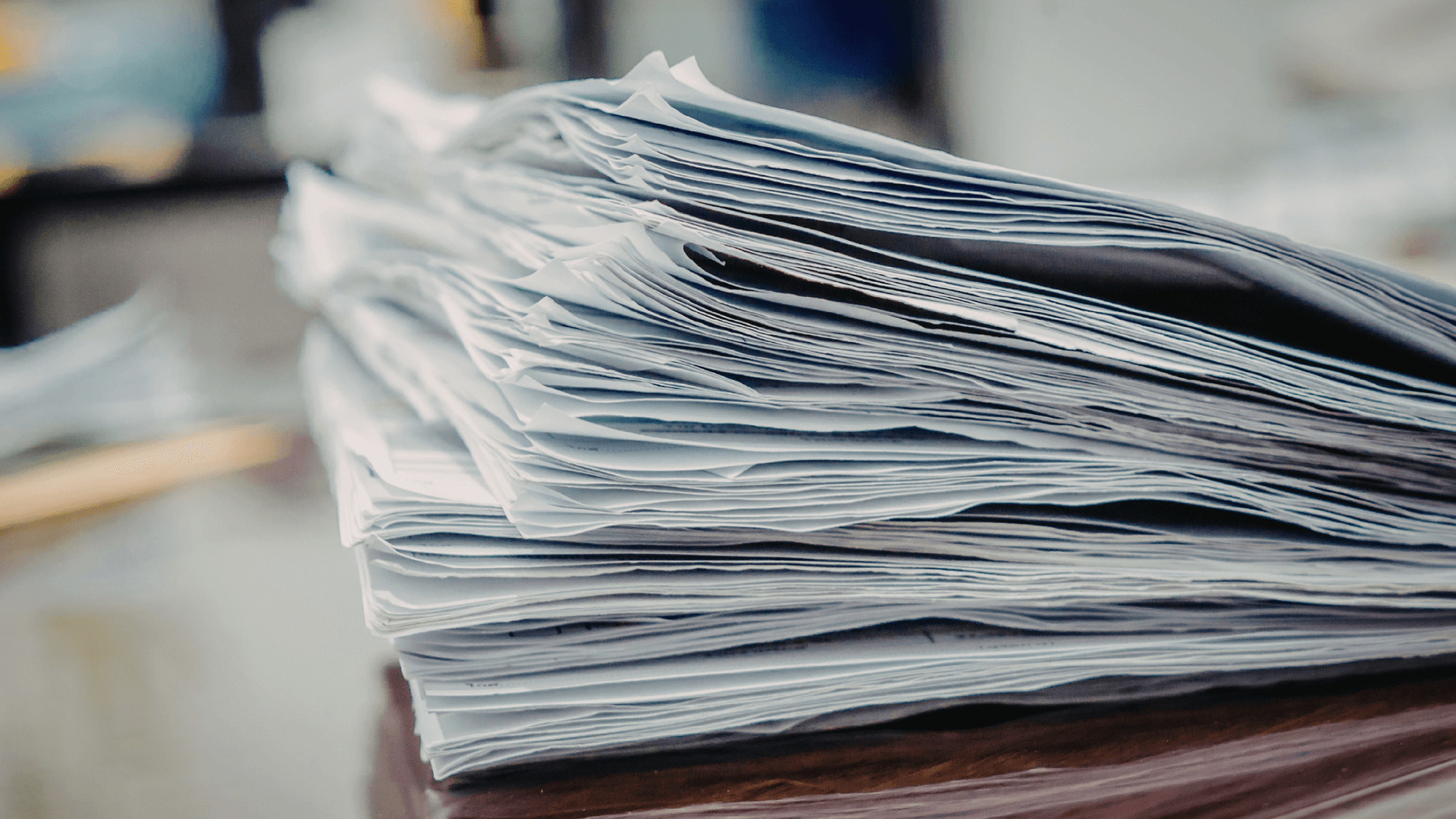 a pile of forms on a desk