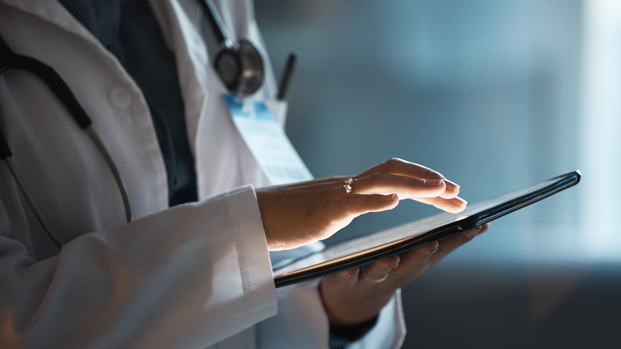 closeup of a clinician using a tablet